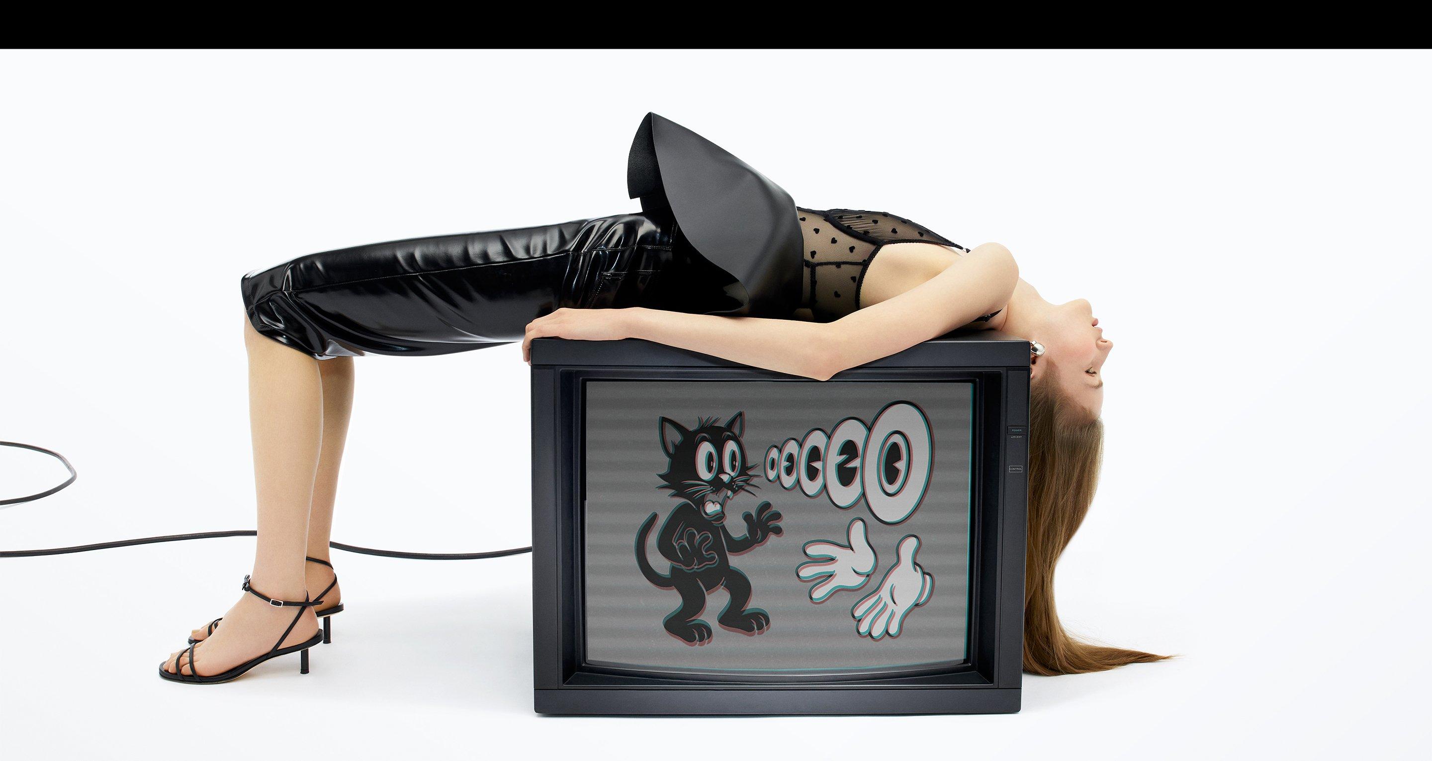 Model wears the Vinyl Zippered Midi Skirt in Black.